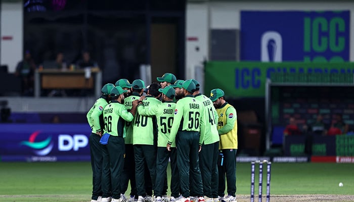 Pakistans players gather during the ICC Champions Trophy match between Pakistan and India at the Dubai International Stadium in Dubai on February 23, 2025. — AFP