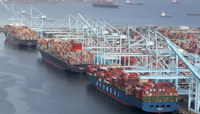 Shipping containers are unloaded from ships at a container terminal at the Port of Long Beach-Port of Los Angeles complex in Los Angeles, California, US, April 7, 2021. — Reuters