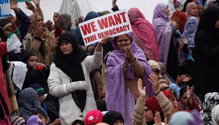 Supporters hold placards during a protest in Islamabad January 17, 2013. —Reuters