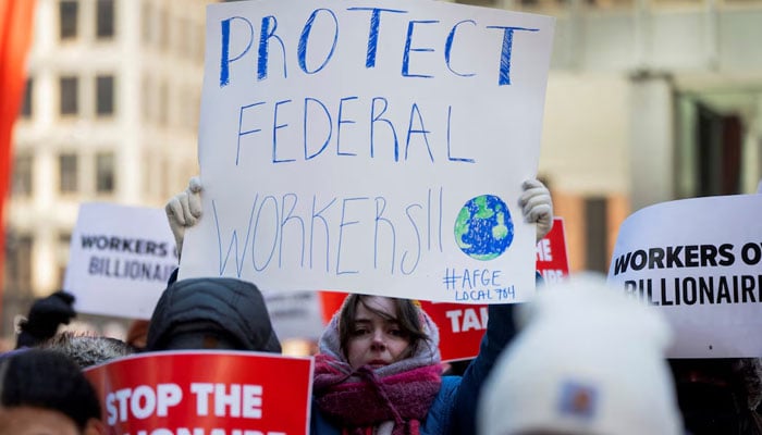 People, including members of the AFGE Local 704, hold placards as they gather for a rally in support of fired EPA probationary employees, at Federal Plaza in Chicago, Illinois, US February 18, 2025. — Reuters