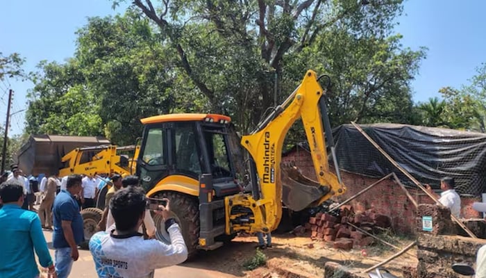 A video of the bulldozer action surfaced on social media, showing a group of people gathered outside the scrap shop. — X/@meNeeleshNRane