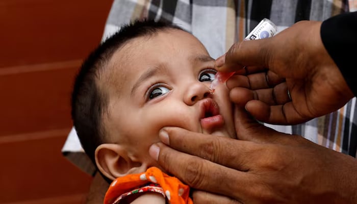 A girl receives polio vaccine drops, during an anti-polio campaign, in a low-income neighborhood in Karachi, on July 20, 2020. — Reuters