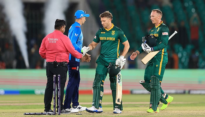 South Africas David Miller and Rassie van der Dussen shake hands with umpire Ahsan Raza and Englands Joe Root after the match. — Reuters