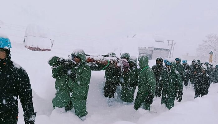 In this handout photo taken and released by the State Disaster Response Force (SDRF) on February 28, 2025, rescuers carry Border Roads Organisation (BRO) workers after an avalanche near Mana village in Chamoli district. — AFP