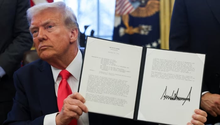 US President Donald Trump holds an executive order signed in the Oval Office, at the White House in Washington, DC, US, February 25, 2025. — Reuters