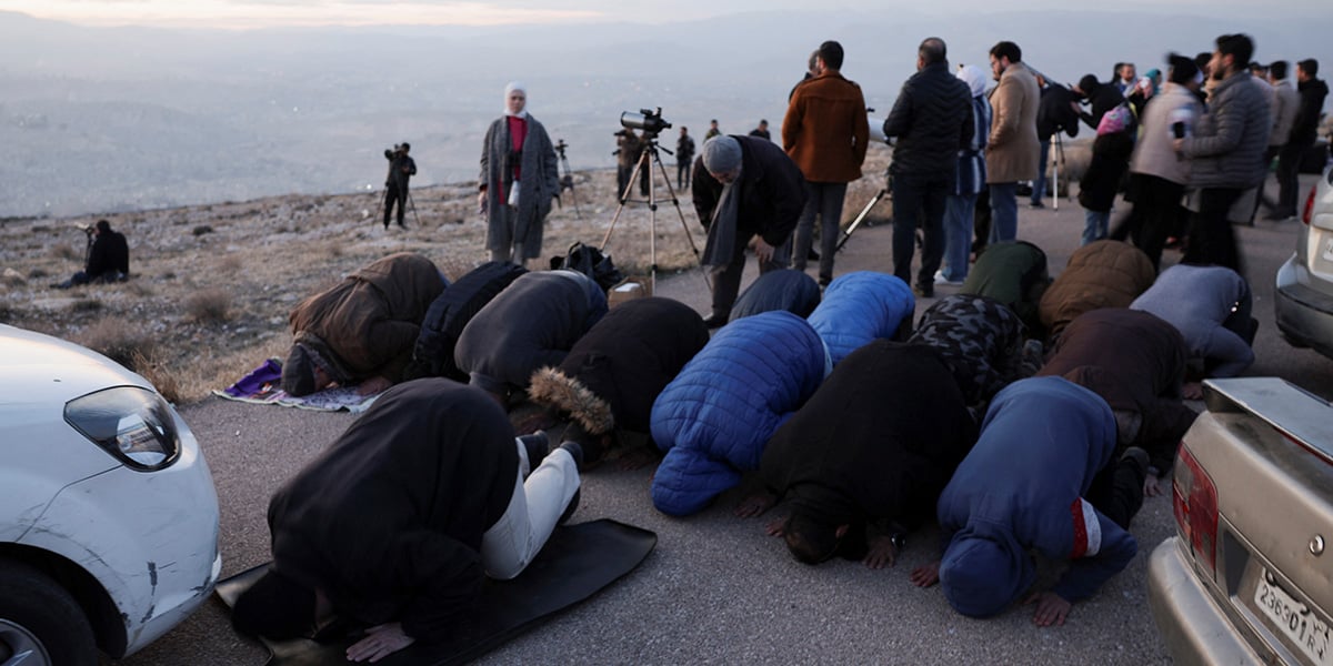 People pray as others look for the position of the moon to determine the start of Ramadan, at Mount Qasioun in Damascus, Syria, February 28, 2025. — Reuters