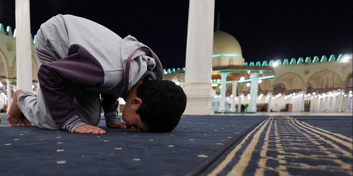 An Egyptian boy worshipper takes part in evening prayers called Taraweeh during the eve of the first night of the holy fasting month of Ramadan, at Amr Ibn El-Aas mosque, the first and oldest mosque ever built on the land of Egypt in old Cairo, Egypt, February 28, 2025. — Reuters