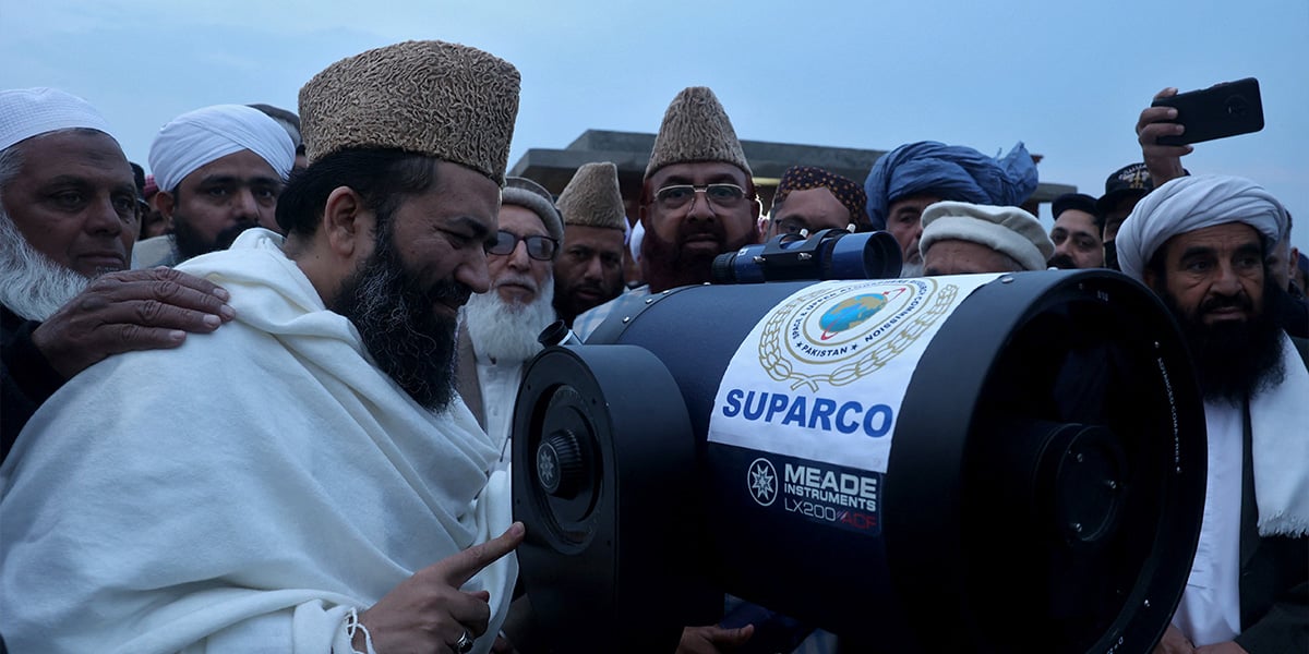 Chairman of Central Ruet-e-Hilal Committee Maulana Abdul Khabeer Azad along with other members use a telescope to look for the new Ramadan moon in Peshawar, February 28, 2025. — Reuters