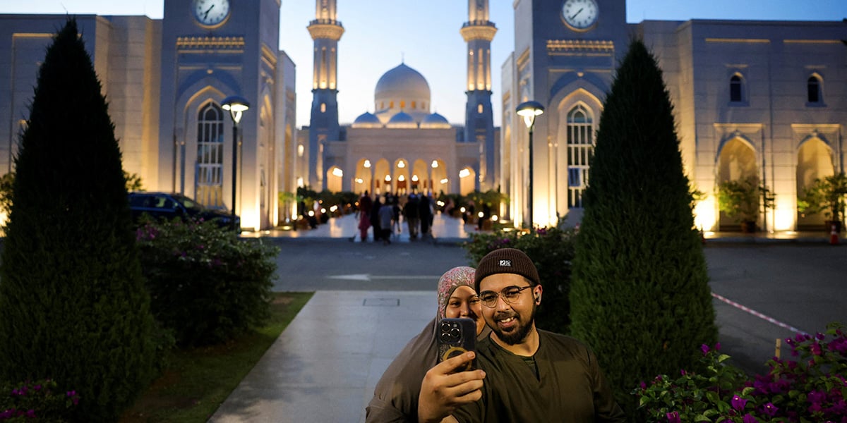 A couple takes a selfie as they go to a mosque to perform the Taraweeh prayer in Seremban, Malaysia, March 1, 2025. — Reuters