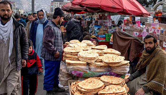 An Afghan man sells traditional flatbreads known as naan in Kabul on February 27, 2025. — AFP