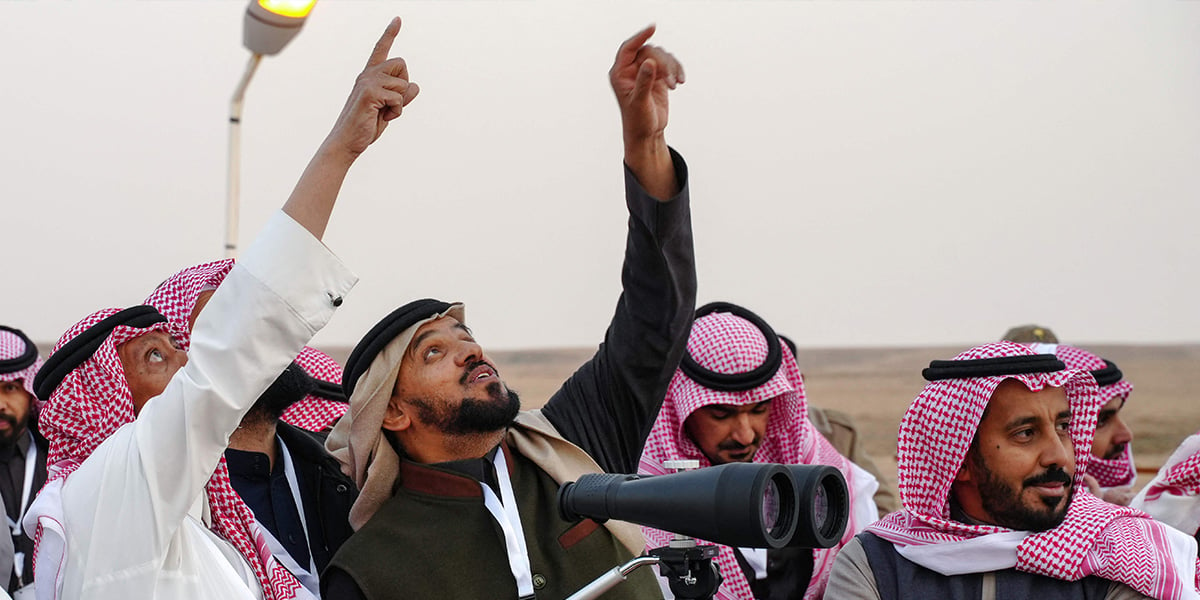 Saudi men look to spot the first crescent of the moon marking the start of the fasting month of Ramadan, in the southern Saudi city of Hautat Sudair, on February 28, 2025.  — AFP