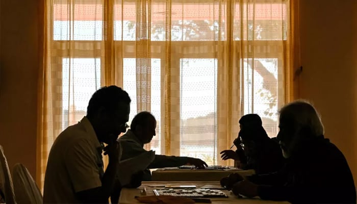 Adult participants compete in a Scrabble championship organised by the Pakistan Scrabble Association at the Beach Luxury hotel in Karachi. — AFP