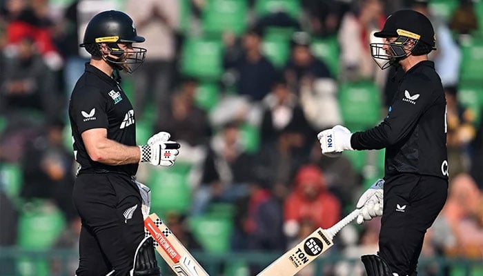 New Zealands Devon Conway (Right) bumps fist with teammate Kane Williamson during the Tri-Nation series second ODI cricket match between New Zealand and South Africa at the Gaddafi Stadium in Lahore on February 10, 2025. — AFP