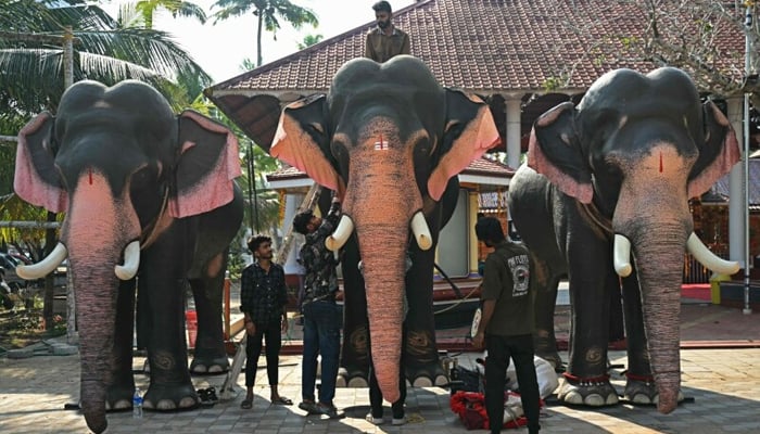 Workers assemble a robotic elephant model (C), newly donated by the Voice for Asian Elephants Society (VFAES) for religious rituals at the Chakkamparambu Bhagavathy temple in Thrissur, in India’s Kerala state on February 24, 2025. — AFP