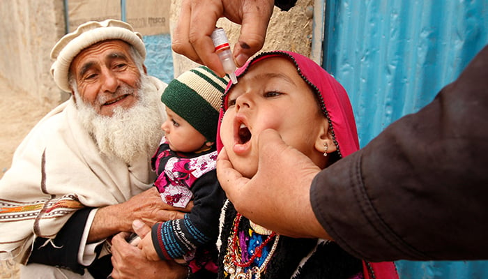 A child receives a polio vaccination during an anti-polio campaign on the outskirts of Jalalabad, March 16, 2015. — Reuters