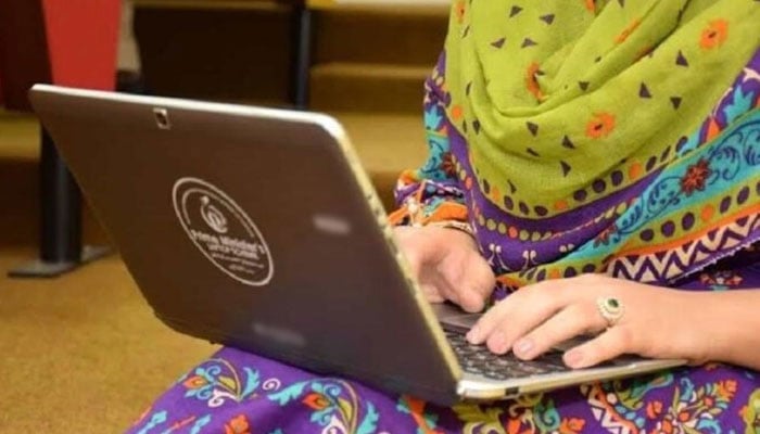 A female student is working on her laptop in this undated photo. — APP/File