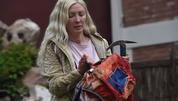 Azul Vieiro with her fathers rucksack and pickaxe. — AFP/File