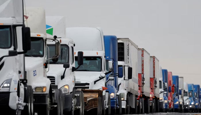 Trucks wait in line to cross into the United States near the border customs control at the World Trade Bridge, in Nuevo Laredo, Mexico on November 26, 2024. — Reuters