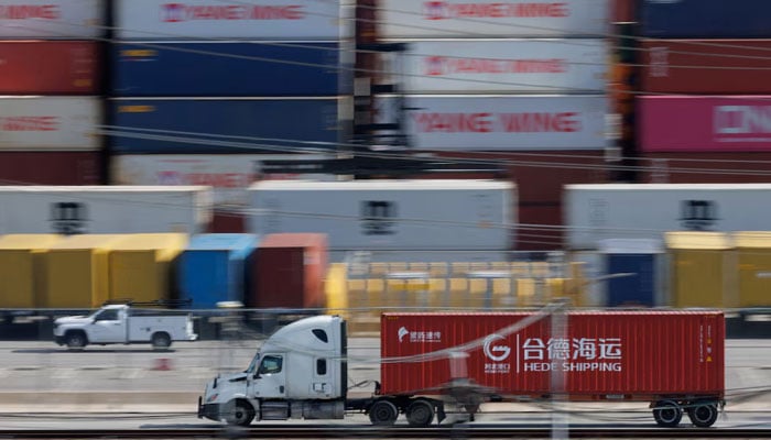 Vehicles drive past shipping containers from China at the China Shipping (North America) Holding Company Ltd facility at the Port of Los Angeles in Wilmington, California, February 4, 2025. — Reyters