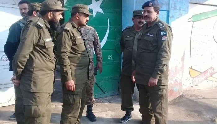 This image shows Punjab police personnel speaking to each other. — AFP/File