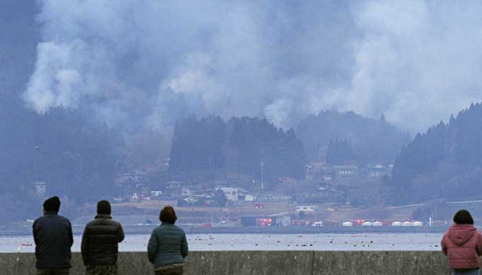 People watch a wildfire site in Ofunato, Iwate Prefecture, northeastern Japan, March 4, 2025, in this photo taken by Kyodo. — Reuters