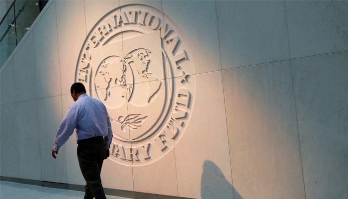 A man walks past the International Monetary Fund (IMF) logo at its headquarters in Washington, U.S., May 10, 2018. — Reuters