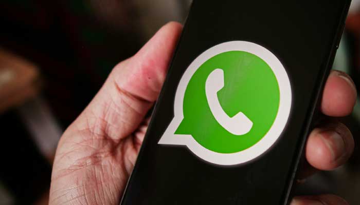 This representational image shows the WhatsApp logo displayed on a phone screen. — Unsplash