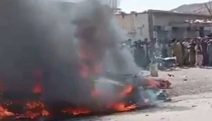 Vehicle on fire after a motorcycle strapped with explosive materials blew up near Naal Bazaar in Khuzdar District, Balochistan, March 5, 2025. — Reporter