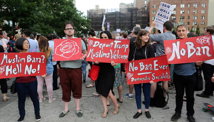 Protesters hold signs against US President Donald Trumps limited travel ban, approved by the US Supreme Court, in New York City, US, June 29, 2017. — Reuters