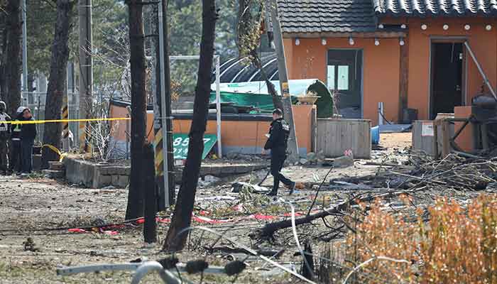 A police officer walks at a cordoned area after South Koreas Air Force said that Mk82 bombs fell from a KF-16 jet outside the shooting range during joint live-fire exercises near the demilitarised zone separating two Koreas in Pocheon, South Korea, March 6, 2025. — Reuters