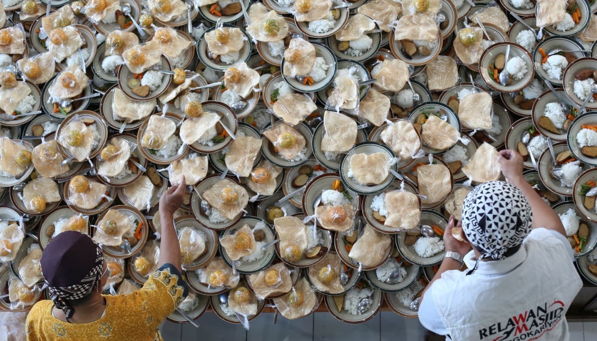 Muslim men prepare meals for iftar to be distributed freely among people at the Jogokariyan Mosque in Yogyakarta, Indonesia. — Reuters/File