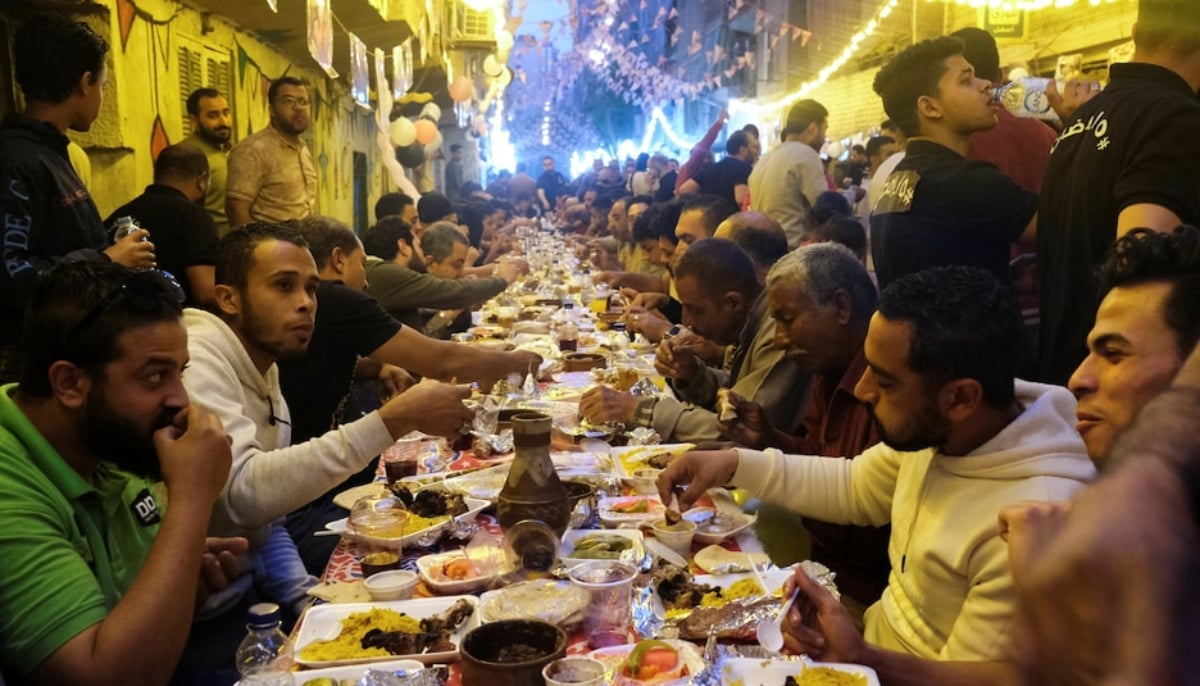 Residents of Ezbet Hamada gather to eat during Iftar, a meal to end their fast at sunset, during the holy fasting month of Ramadan in Mataria, Cairo, Egypt, April 16, 2022. — Reuters