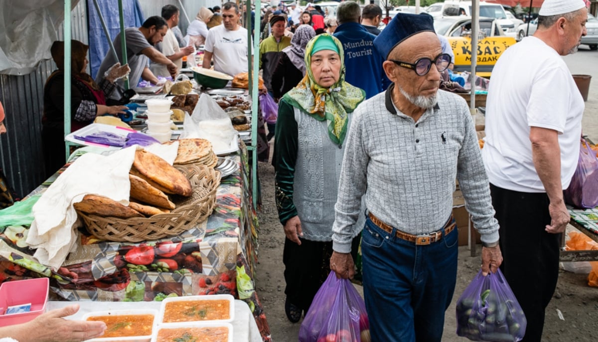 An elderly couple does shopping at a market in Kyrgyzstan. — Eurasia Net