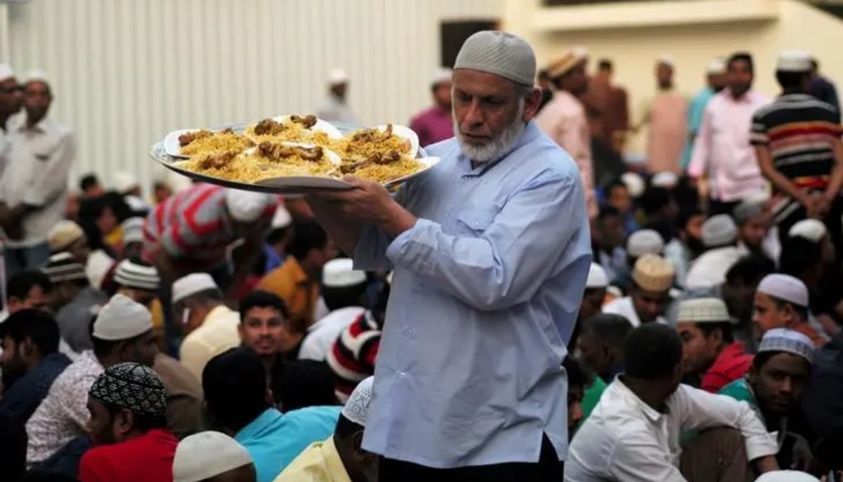 A volunteer serves food outside a mosque before Iftar (breaking fast) during the holy fasting month of Ramadan, in Manama, Bahrain, May 10, 2019. — Reuters