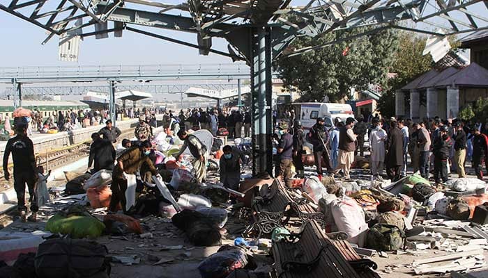 Police personnel and people gather at the site amid the debris after a bomb blast at a railway station in Quetta on November 9, 2024. — Reuters