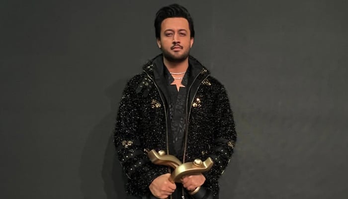 Pop icon Atif Aslam posing with his awards at an awards show. — Instagram/@atifaslam