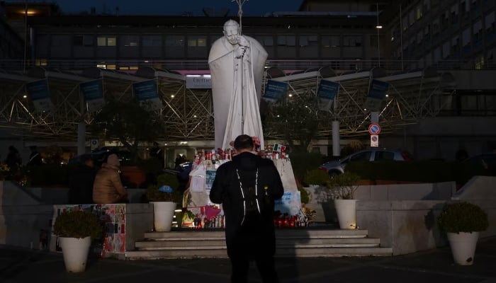 People gather near the statue of late Pope John Paul II outside Gemelli Hospital where Pope Francis is admitted for treatment, in Rome, Italy, March 6, 2025. — Reuters