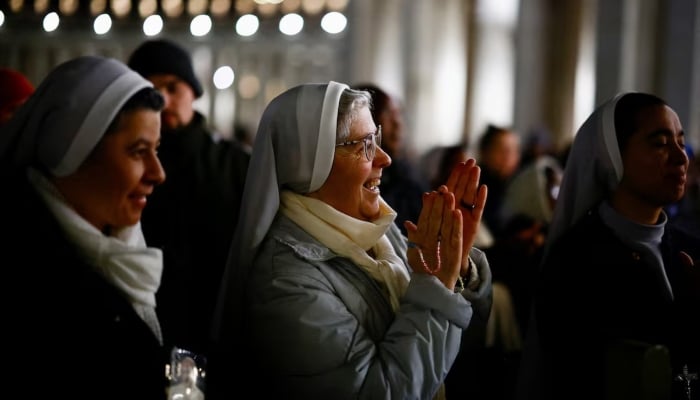 Faithful listen to an audio message by Pope Francis at the Vatican, March 6, 2025. — Reuters