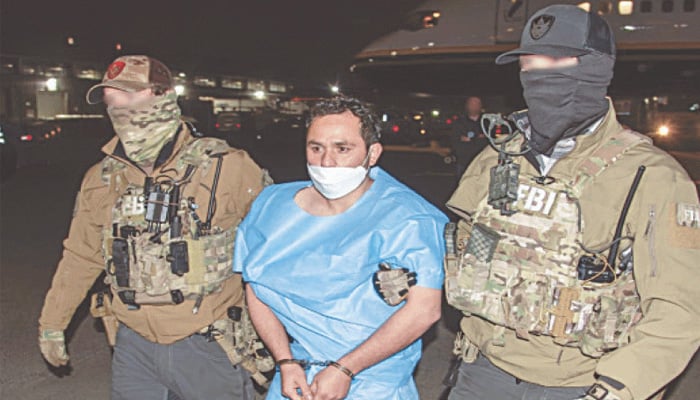 FBI agents escort Sharifullah following his arrival in the US. —X@FBIDirectorKash