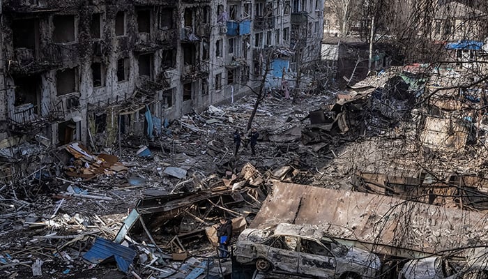 People are at the site of an apartment building run over by a Russian missile strike, in the middle of Attack Russias against Ukraine, in the city of Dobropillia, Donetsk region, Ukraine March 8, 2025. - Reuters