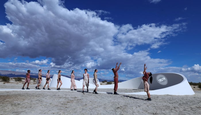 Dancers perform in front of French-American artist Sarah Meyohass piece Truth Arrives in Slanted Beams ahead of the opening of the Desert X exhibit spread across Californias Coachella Valley. — AFP