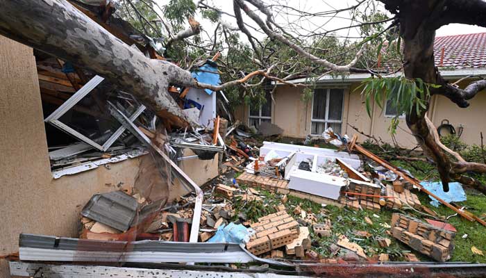 Debris lies at a damaged house by a fallen gum tree ahead of Tropical Cyclone Alfreds landfall, at Mudgeeraba on the Gold Coast, Australia, March 7, 2025. — Reuters