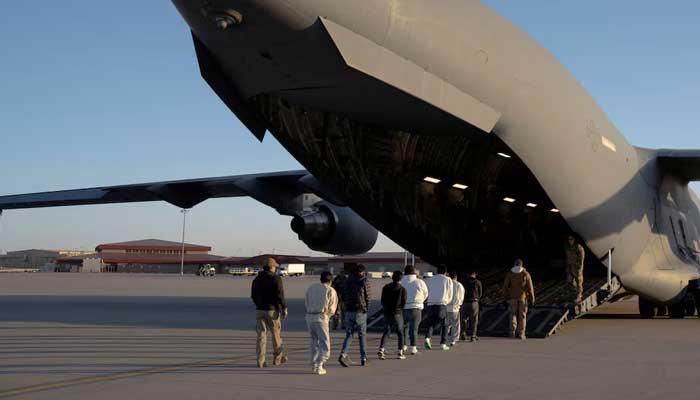 US Customs and Border Protection security agents guide detained migrants to board a US Air Force C-17 Globemaster III aircraft for a removal flight at Fort Bliss, Texas, US, January 23, 2025. — Reuters