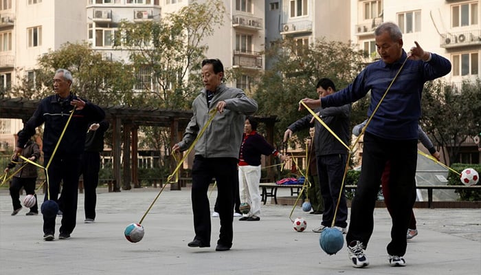 Retirees practice Cola Ball with music, an invented community activity in central Beijing. — Reuters/File