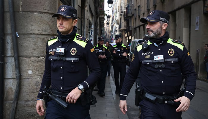 Spanish policemen walk on a street in this undated image. — Barcelona City Council website