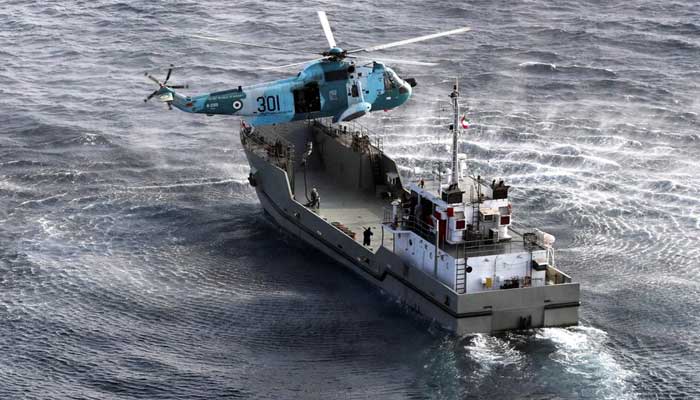 A warship and a helicopter attend a joint naval exercise of the Iranian, Chinese and Russian navies in the northern Indian Ocean on January 20, 2022. — Reuters