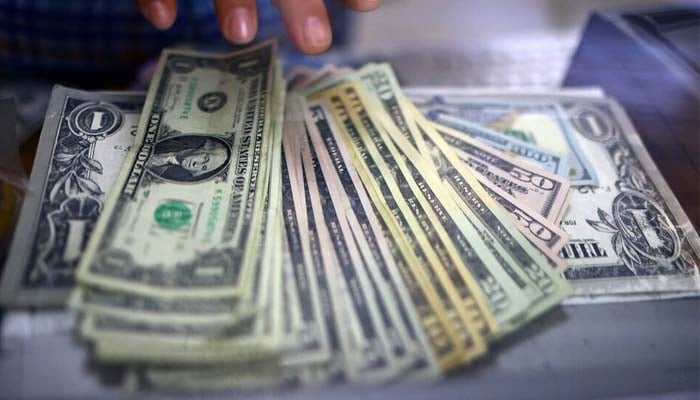 The employee of a currency exchange shop counts US dollar banknotes in Ciudad Juarez, Mexico July 27, 2023. — Reuters