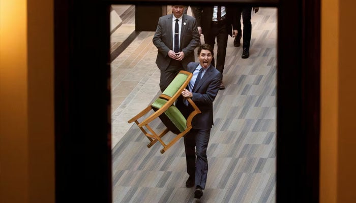 Canadas Prime Minister Justin Trudeau carries his chair from the House of Commons on Parliament Hill today. — Reuters