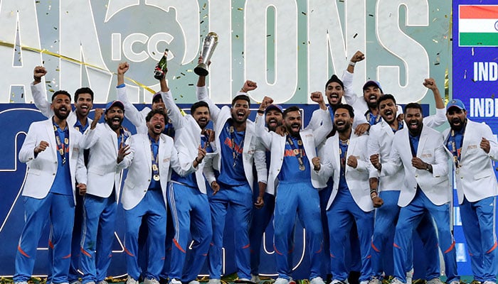 India players celebrate with the trophy on the podium after winning the ICC Mens Champions Trophy 2025 final against New Zealand at the Dubai International Stadium in UAE on March 9, 2025. — Reuters