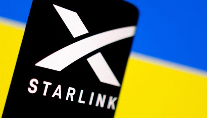 Starlink logo is seen on a smartphone in front of displayed Ukrainian flag in this illustration taken February 27, 2022. — Reuters